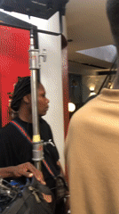 Film crew conducts indoor studio shoot with interview setup