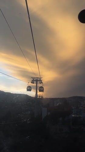 Cable cars operate through La Paz at sunset