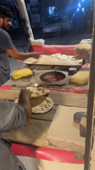 Nighttime street food vendors serve customers in Pakistan cities