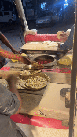Nighttime street food vendors serve customers in Pakistan cities