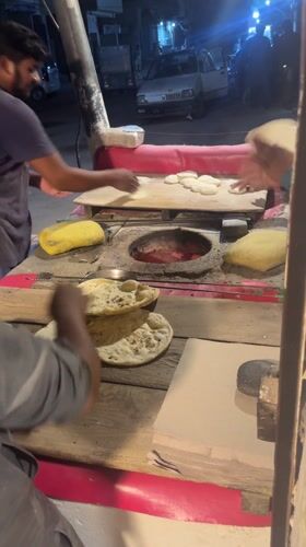 Nighttime street food vendors serve customers in Pakistan cities