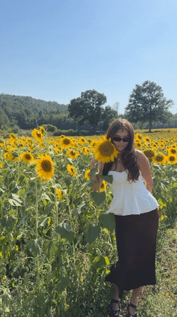 Posing among sunflowers in rural Tuscany, July afternoon