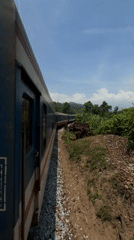 Train spotted on curved tracks near overpasses in Huế
