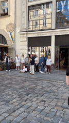 Street musicians perform near outdoor cafe in Lviv