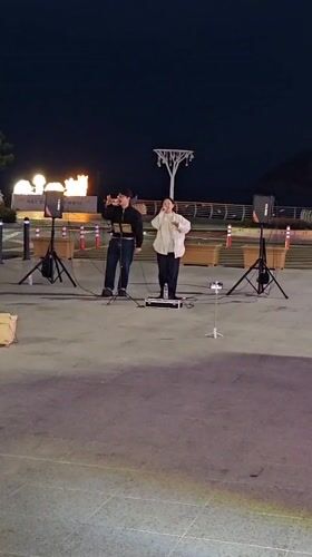 Street musicians perform nighttime concert in Ulsan, South Korea