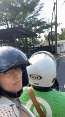 Motorcycles navigate residential streets in Ubud District, Indonesia