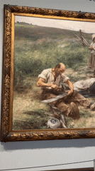 Museum visitor documents historical painting in Amsterdam