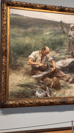 Museum visitor documents historical painting in Amsterdam