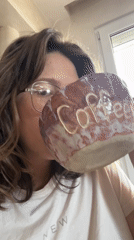 Woman enjoys coffee from handcrafted ceramic mug in Podgorica