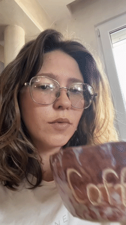 Woman enjoys coffee from handcrafted ceramic mug in Podgorica