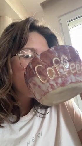 Woman enjoys coffee from handcrafted ceramic mug in Podgorica