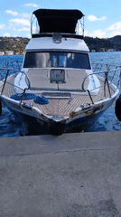 White motorboat docked at a Sarıyer pier on the Bosphorus