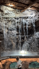 Visitor explores grotto-themed venue with waterfalls, carousel in Podgorica