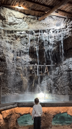 Visitor explores grotto-themed venue with waterfalls, carousel in Podgorica