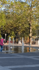 Afternoon at a Mykolaiv park fountain plaza, dogs and all