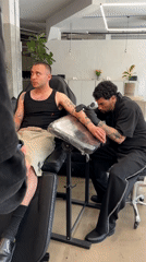 Man gets forearm tattoo at London parlor Thursday afternoon