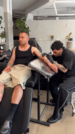 Man gets forearm tattoo at London parlor Thursday afternoon