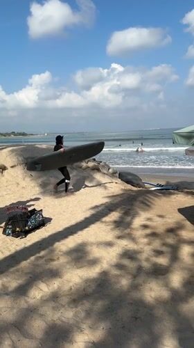 Busy morning surf session at Kuta Beach, Bali