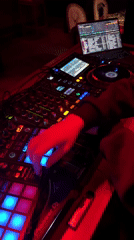 DJ performs with Pioneer equipment under red lights in Moscow