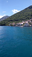 Calm waters and mountain scenery captured near Lepetane, Montenegro