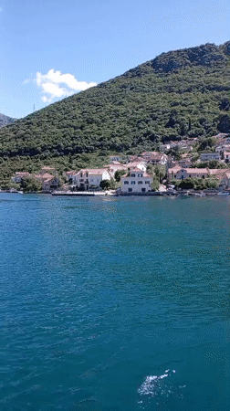 Calm waters and mountain scenery captured near Lepetane, Montenegro