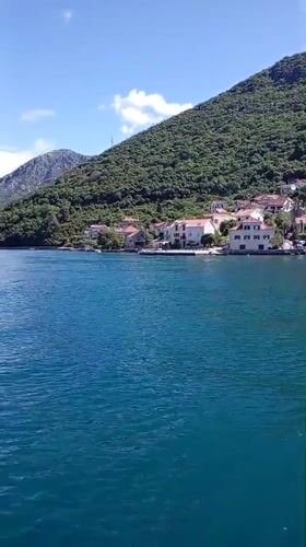 Calm waters and mountain scenery captured near Lepetane, Montenegro