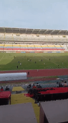 Soccer match played at empty stadium during evening hours