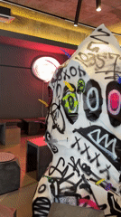 Graffiti-marked abstract sculpture observed in Seoul interior space