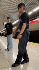 Two people observed waiting at Barcelona subway platform