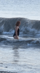 Typical beach day unfolds at Kuta with swimming, photos