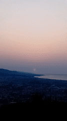Barcelona at sunset, viewed from above the city