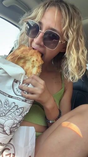 Quick bread snack in a parked car, Nigavan, Armenia