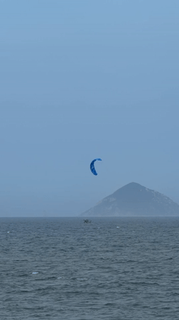 Nha Trang beachfront morning — kites, scooters, and everyday coastal life