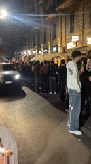 Nighttime crowds gather at Milan restaurants and metro stations