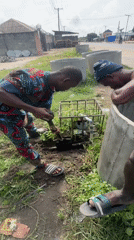 Hands-on excavation work beside concrete structures in Badagry