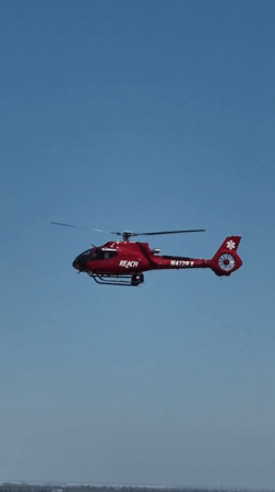 REACH air medical helicopter in flight over Sacramento