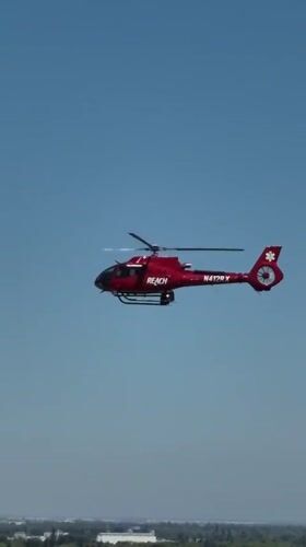 REACH air medical helicopter in flight over Sacramento