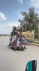 Celebratory crowds pack vehicles in Bukuru, Nigeria streets