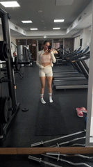 Woman documents gym workout routine in Dubai fitness center