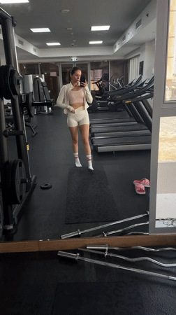 Woman documents gym workout routine in Dubai fitness center