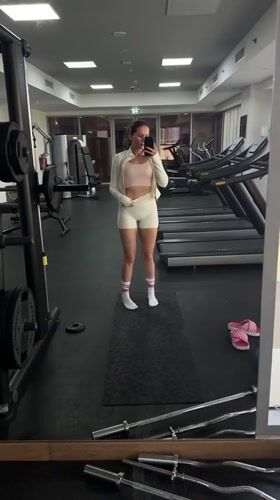 Woman documents gym workout routine in Dubai fitness center