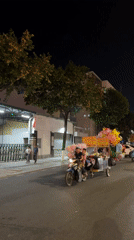Street vendors work illuminated Nha Trang streets with balloons, carts