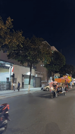 Street vendors work illuminated Nha Trang streets with balloons, carts