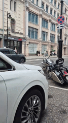 Street-level Moscow: mixed architecture, parked vehicles, docked scooters