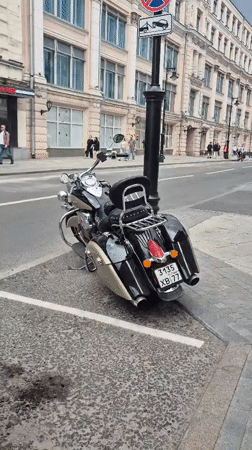 Street-level Moscow: mixed architecture, parked vehicles, docked scooters