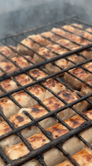 Sausages grilling over coals captured by witnesses May 30