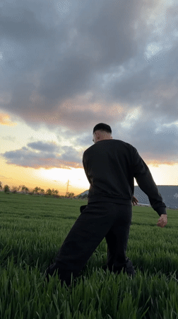 Man performs umbrella backflips in Bulgarian field