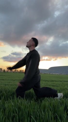 Man performs umbrella backflips in Bulgarian field
