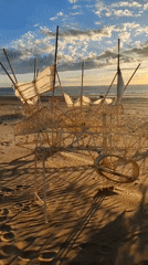 Sunset art installations dot Scheveningen beach at low tide