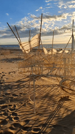 Sunset art installations dot Scheveningen beach at low tide